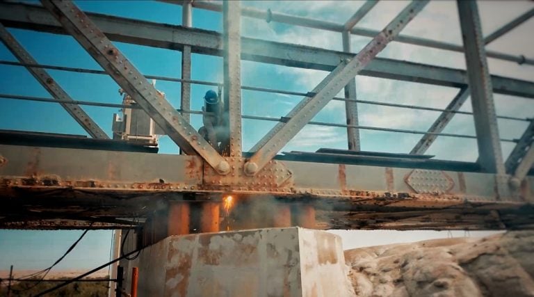 Thermal Lance cutting old rusted steel bridge demolition
